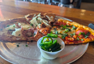 The Austin Beer Garden Brewing Co. (The ABGB) signature dishes Muffaletta Sandwich
Bacon Pie Pizza
Shrimp and Grits